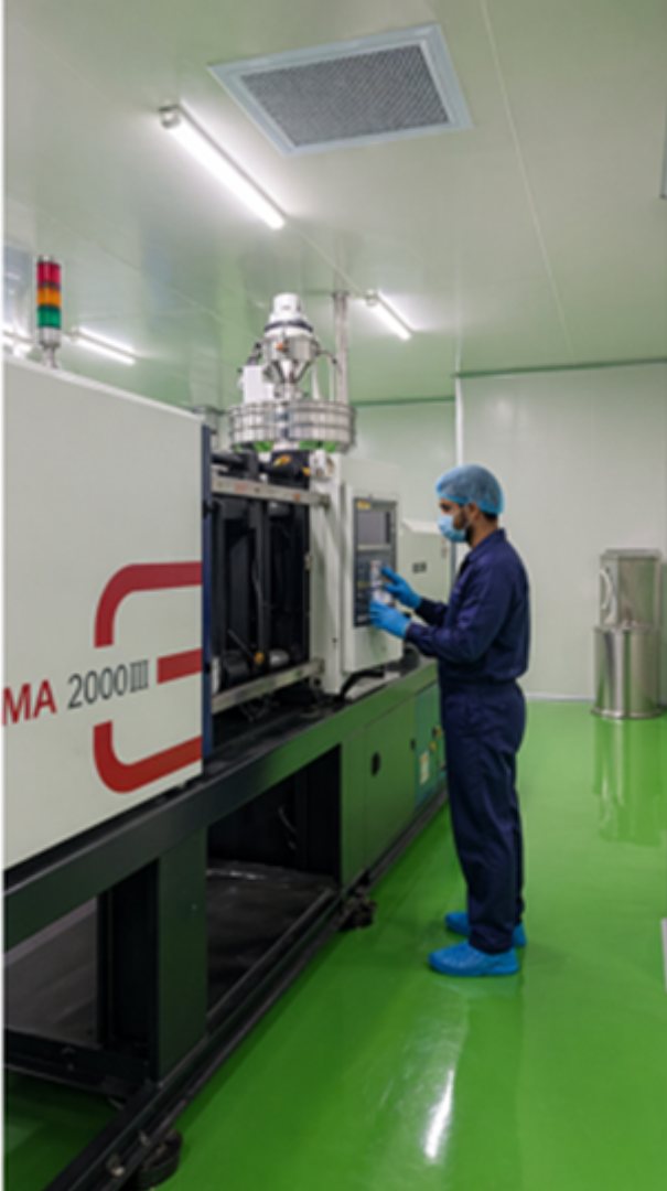 Operator at molding machine control panel